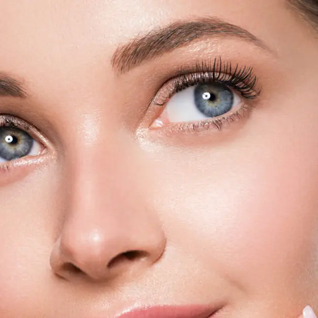 Woman with radiant skin, natural eye makeup, and healthy complexion after a professional facial treatment at Sangkent Beauty House.